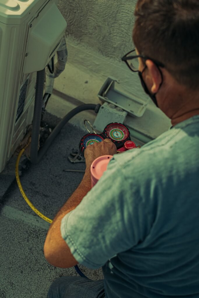 Professional technician servicing an outdoor air conditioning unit